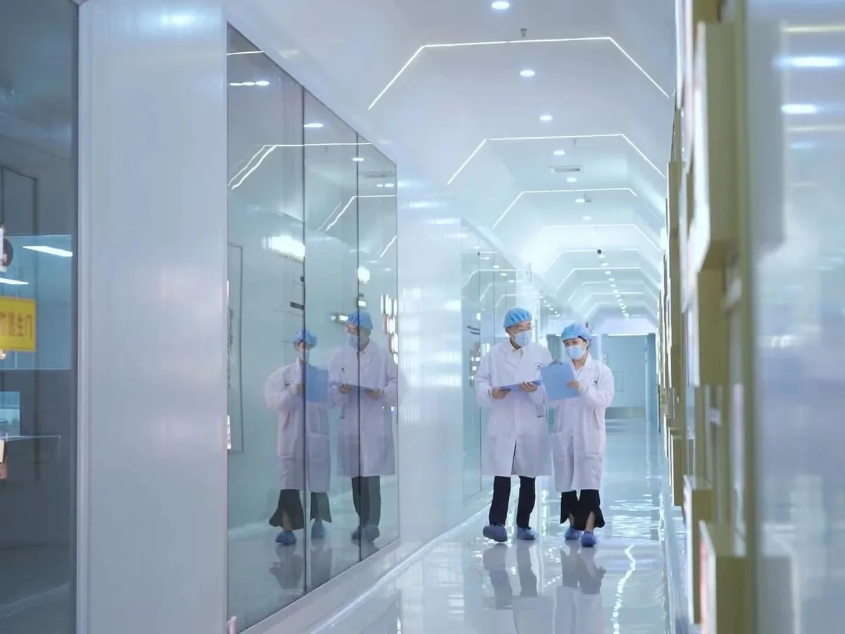 Client audit walkthrough in the production corridor